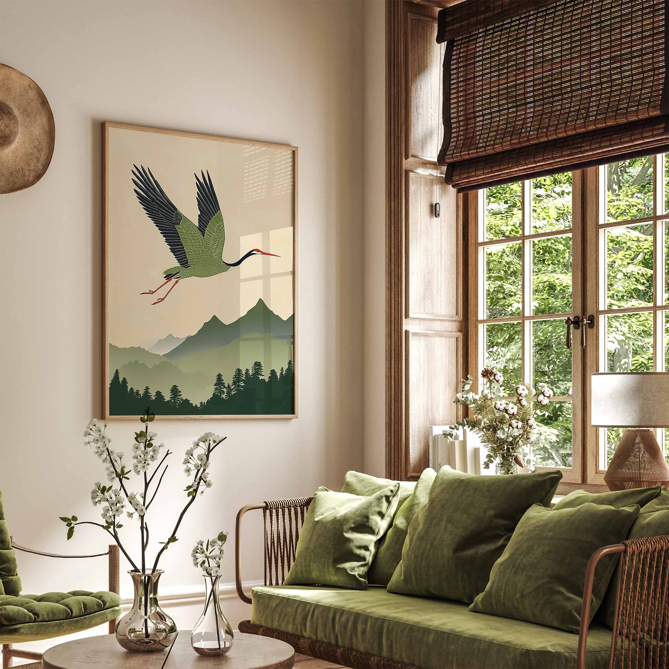 Living room with green sofa, decorative pillows, and a japanese painting of a bird flying over a mountain.
