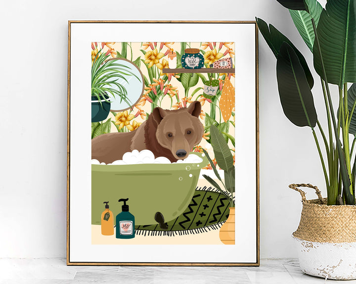 A quirky animal art print of a funny brown bear relaxing in the bathtub in a colourful botanical bathroom.  This modern abstract animal wall art would look great in a kids bathroom, nursery or playroom which has a fun animal or cottage core theme.